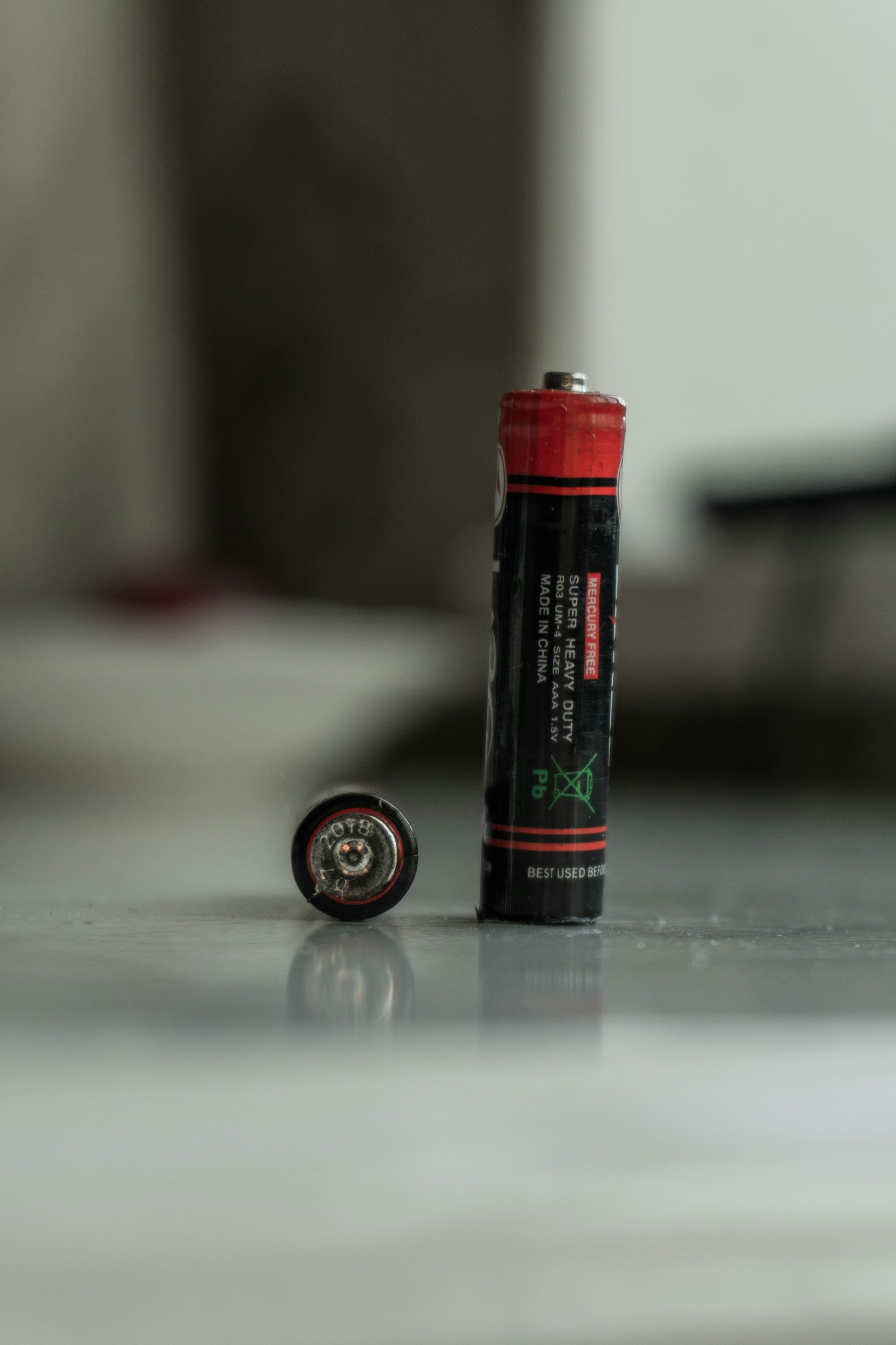 Two AA batteries shown as a power source for automatic coop door controllers