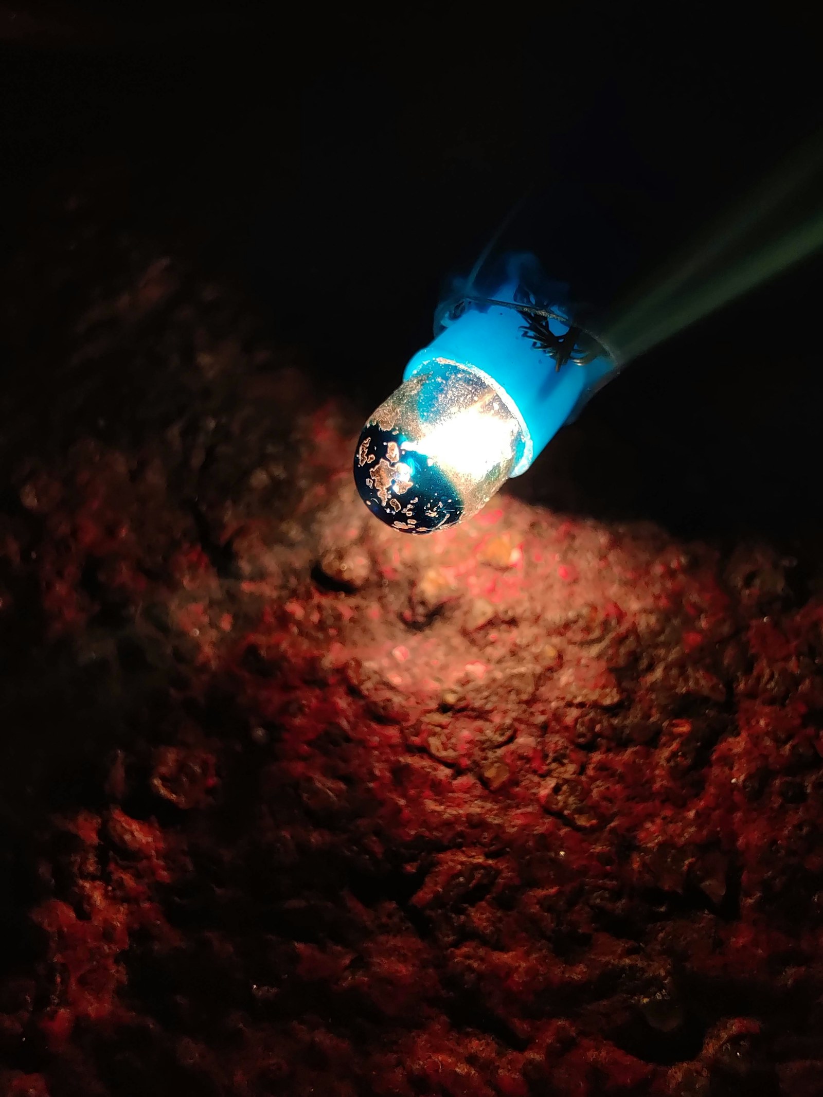 Bright flashlight shining in darkness