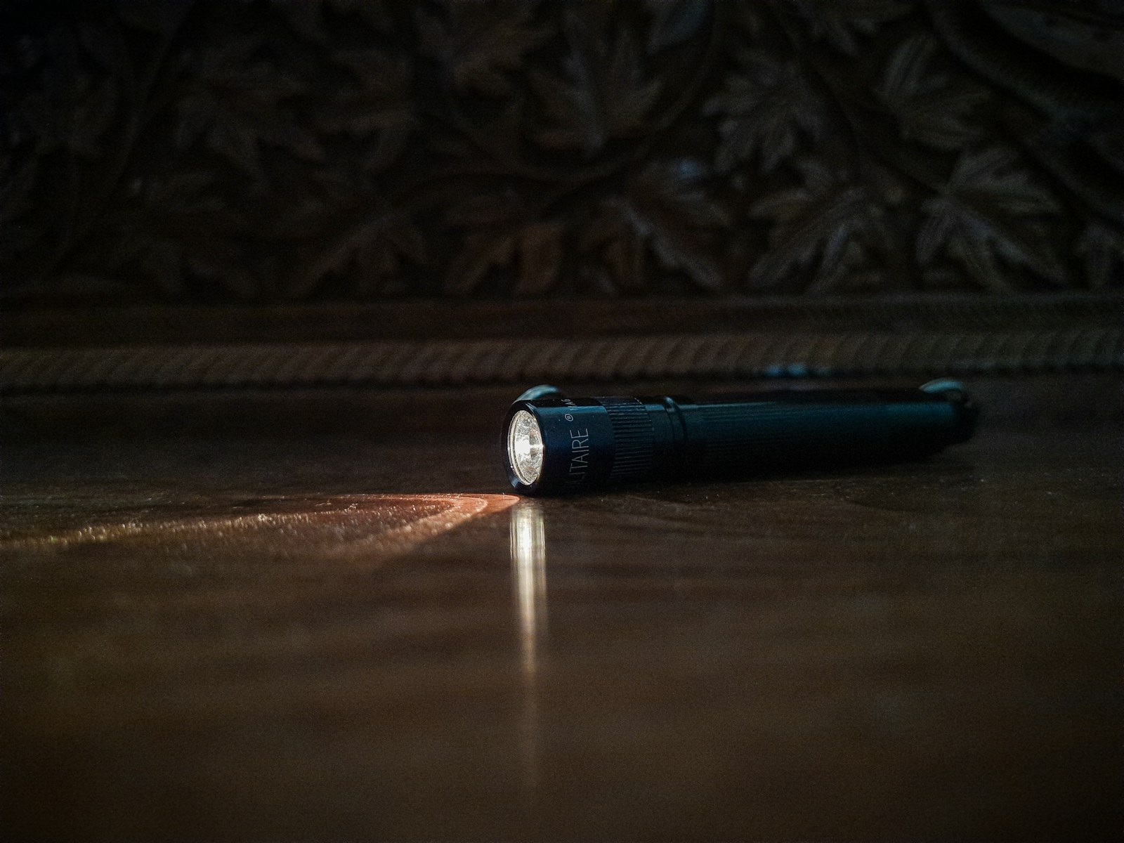 Flashlight casting a beam in a dark room