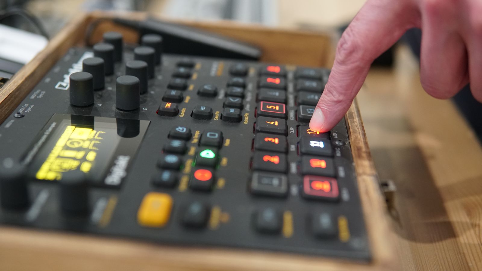 Finger pressing an electronic control button