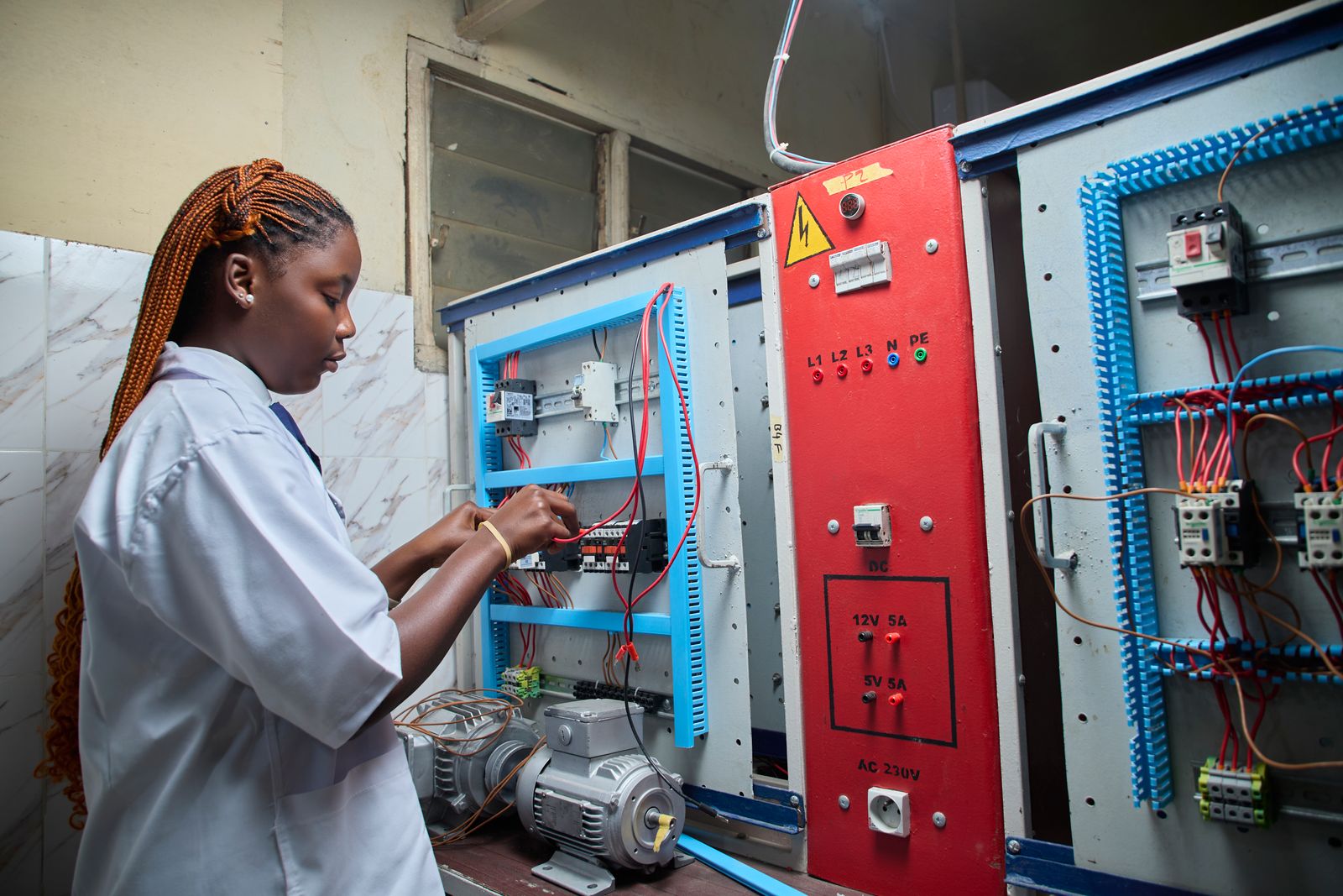 Technician repairing a control panel