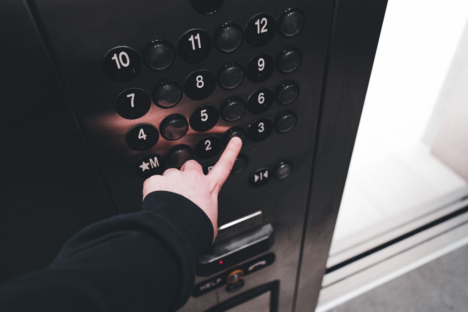 Person pressing an elevator control button
