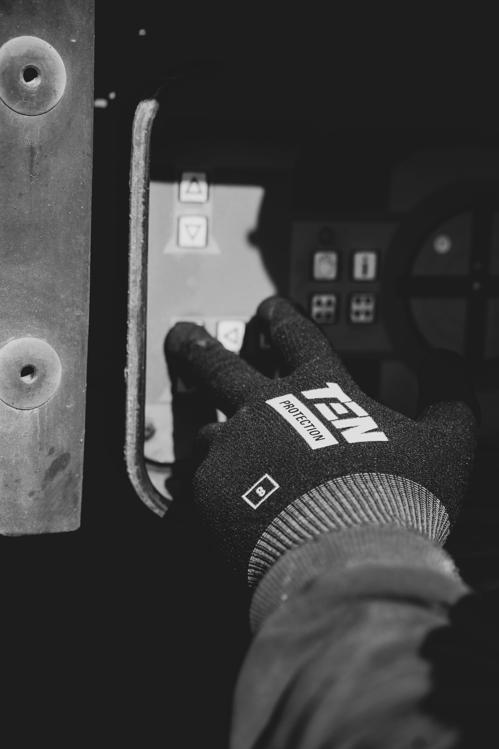 Worker pressing control-panel buttons