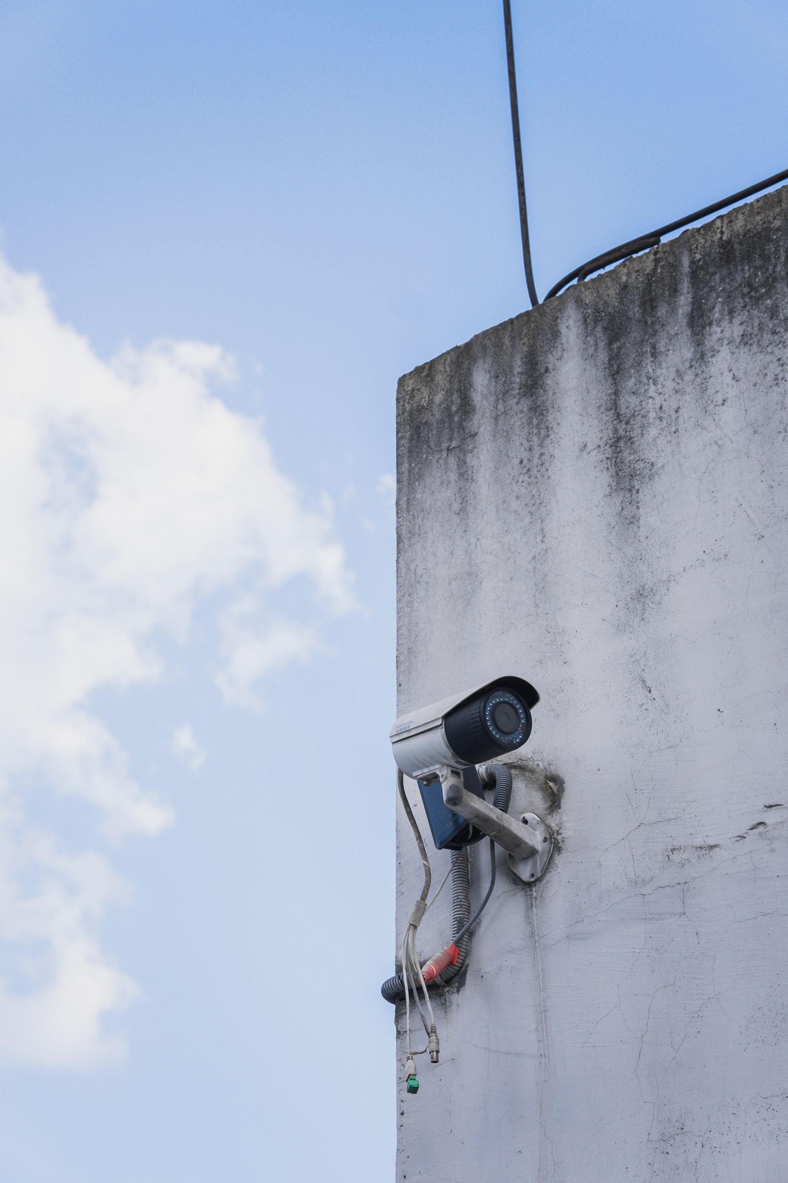 Outdoor security camera on a concrete wall