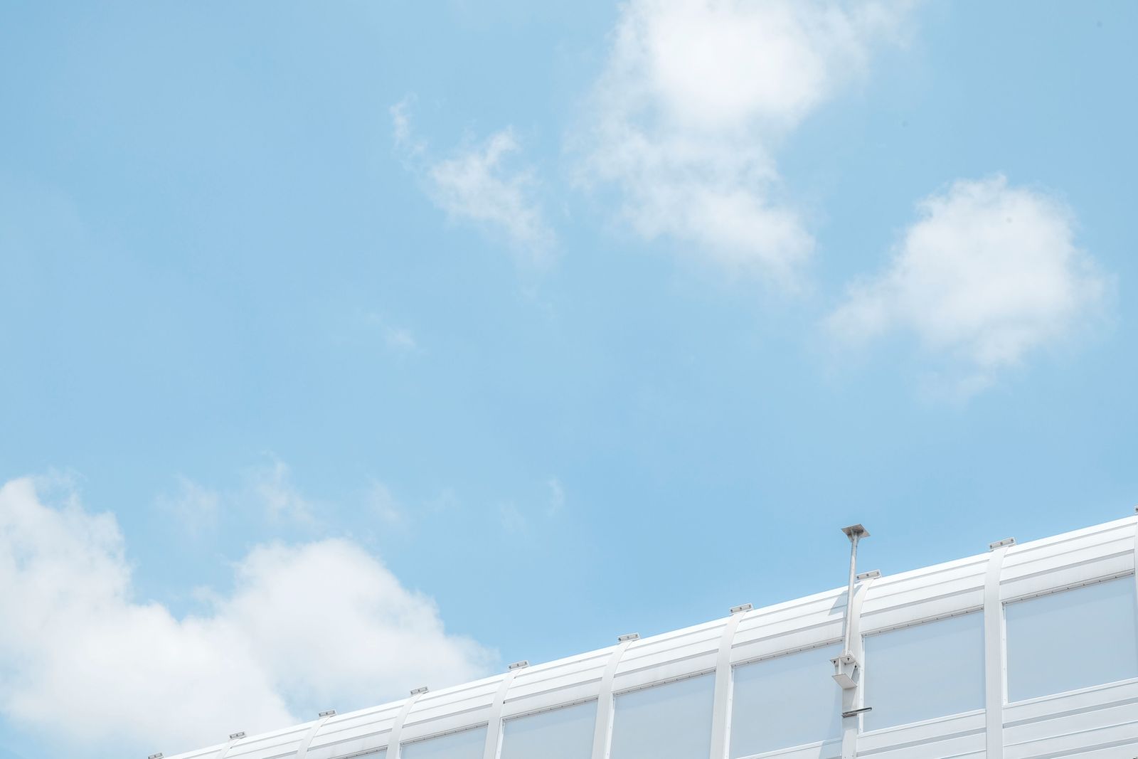 Security camera against blue sky